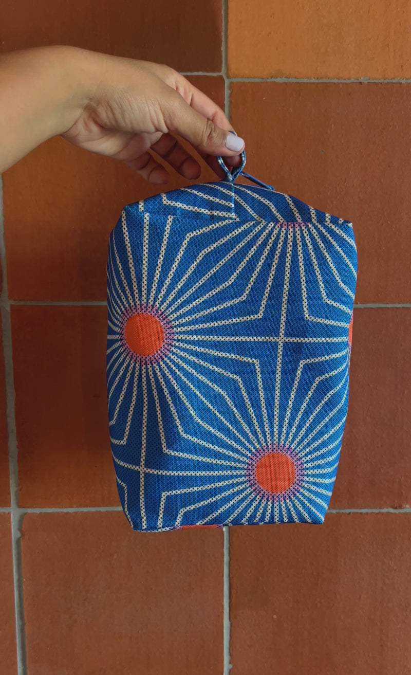 short video of a blue toiletry bag with a sun geometric print