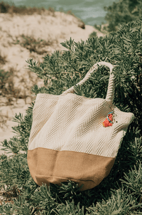 oversized beach bag with pockets made of cotton and burlap, laying on the beach