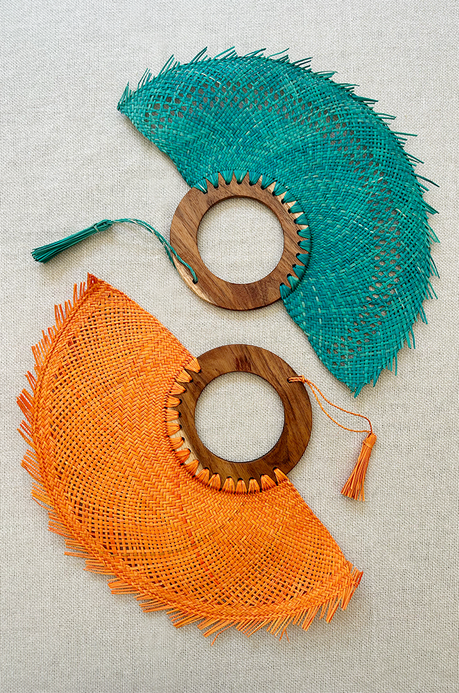 colorful woven fans with circular wooden handles